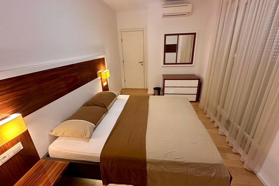 Bedroom with double bed, mirror and chest of drawers