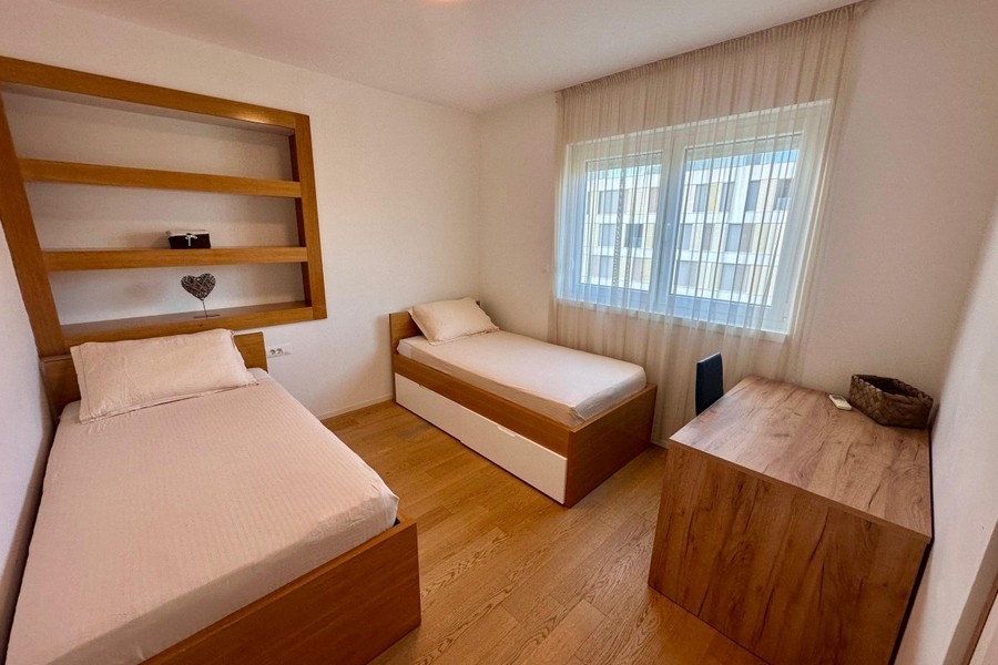 Second bedroom with single beds and shelf