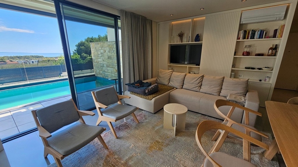 Modern living room with pool and sea views