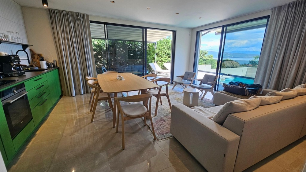 Open kitchen with dining table and sea views