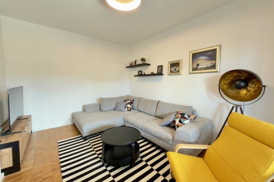Bright living room with corner sofa and seating area
