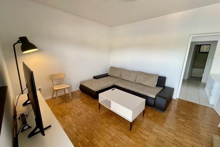 Cozy living area with sofa and television