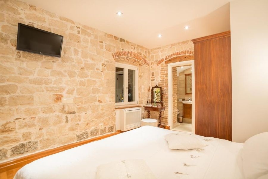 Bedroom with natural stone wall and double bed