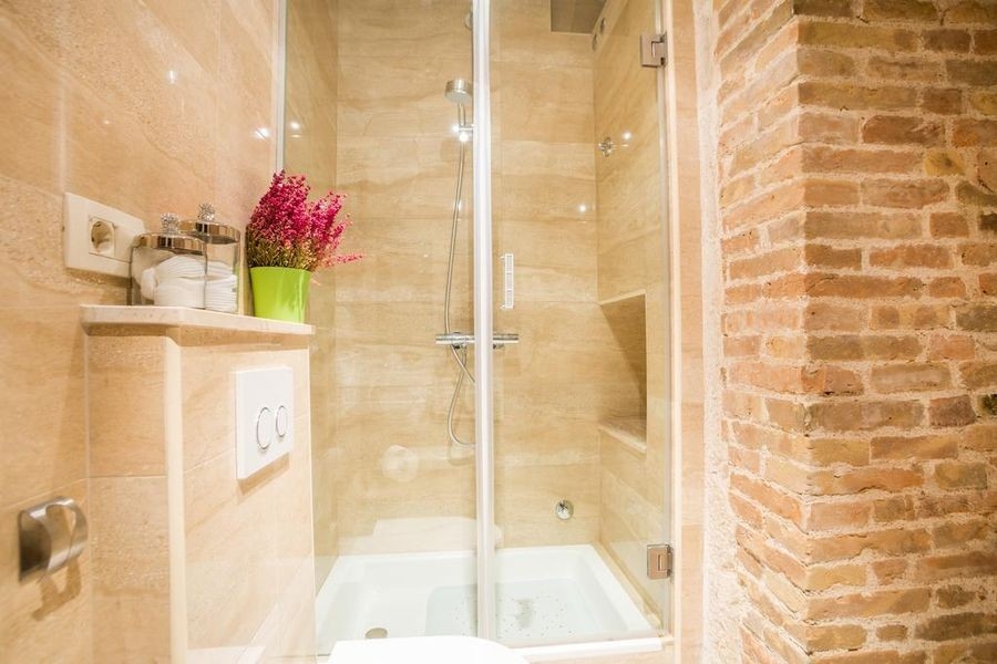Bathroom with shower and natural stone wall