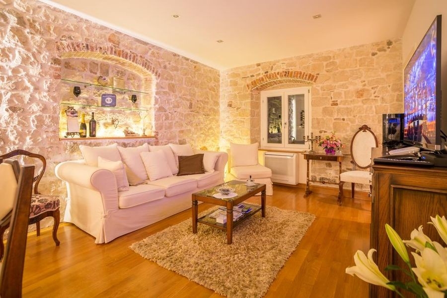 Living room with natural stone wall and parquet floor