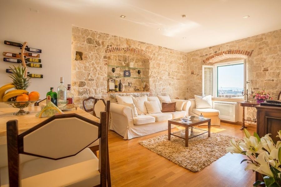 Bright living area with sofa and parquet floor