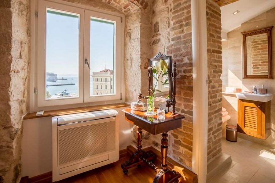 Room with sea view and natural stone wall