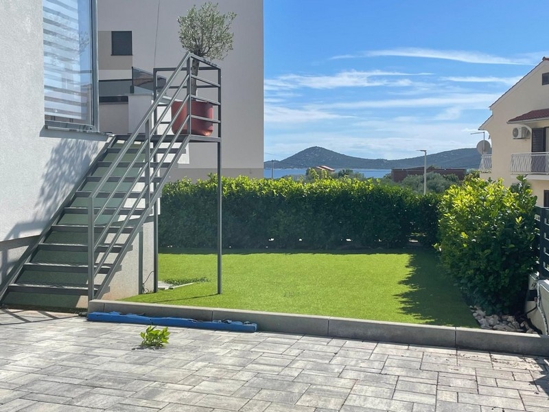 Garden with external stairs and sea views