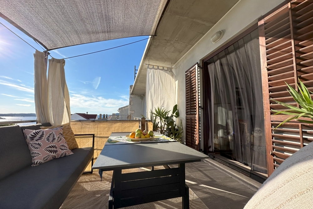 Covered terrace with seating area and view