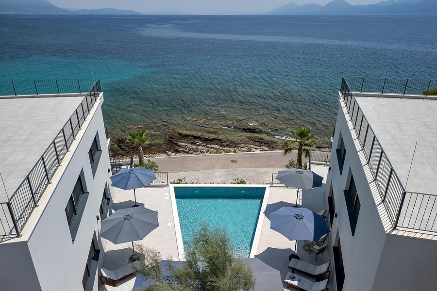 Aerial view of apartment with pool by the sea