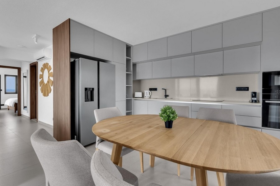 Open kitchen with dining table and cooking island