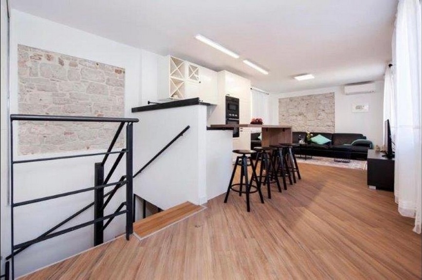 Open living area with natural stone wall