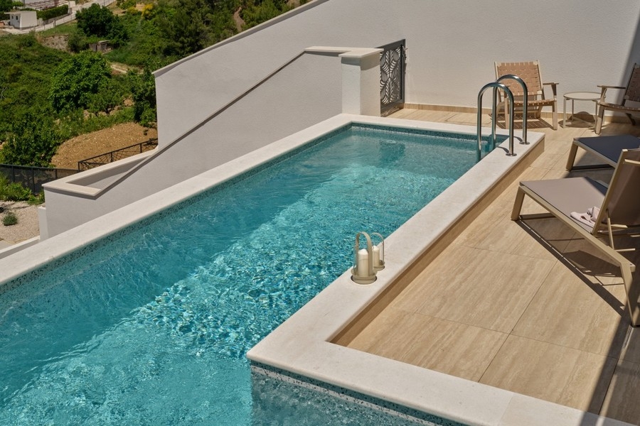 Pool area with sun loungers and terrace