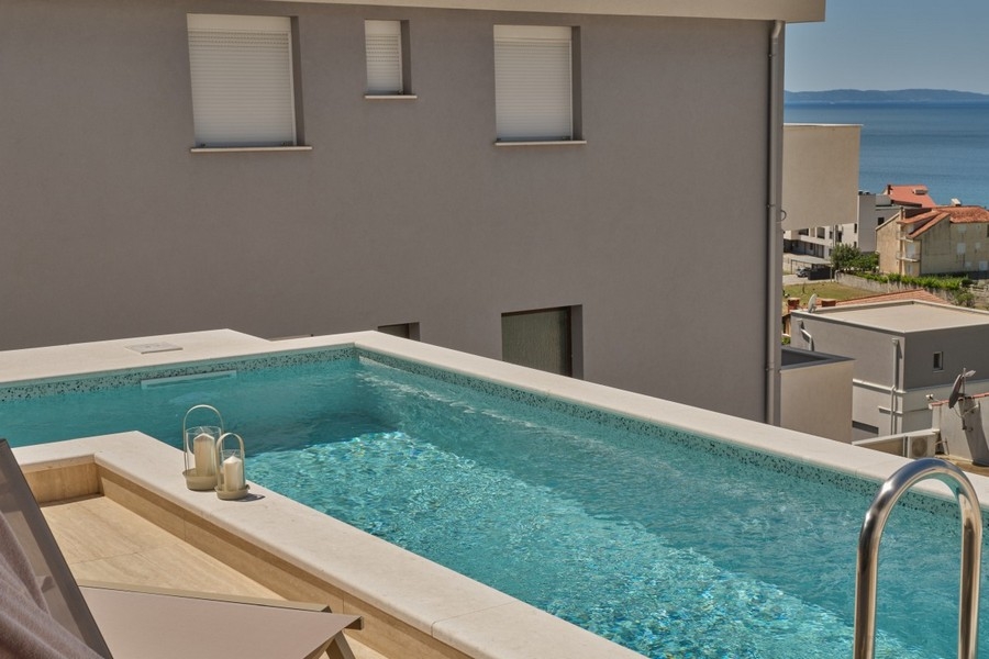 Pool with villa facade and sea view in Croatia