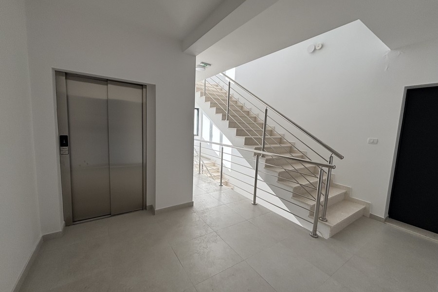Entrance area with elevator and stairs