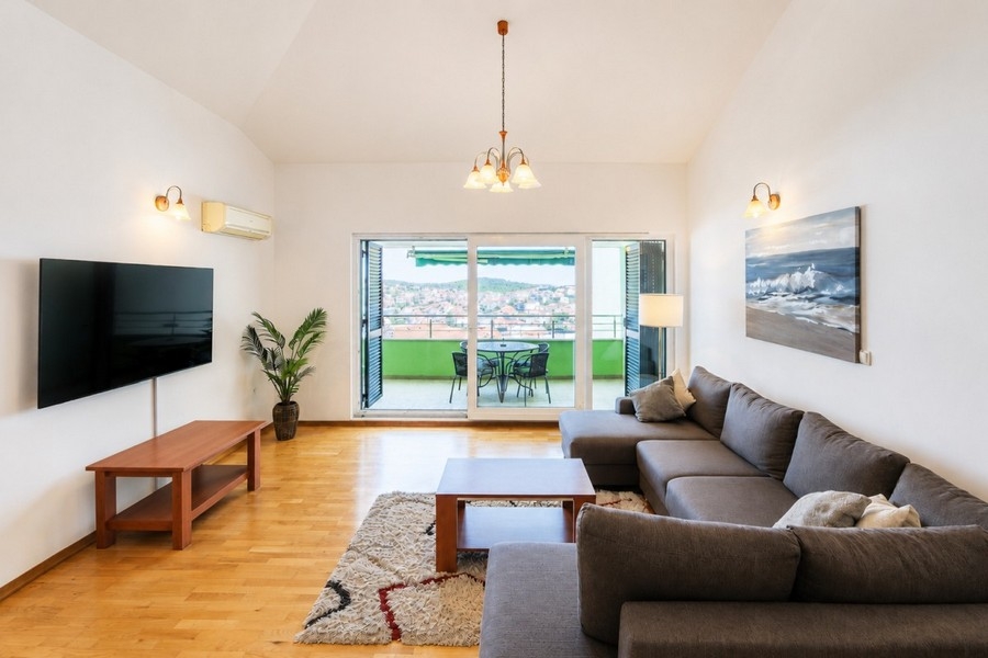 Living area with television and balcony access