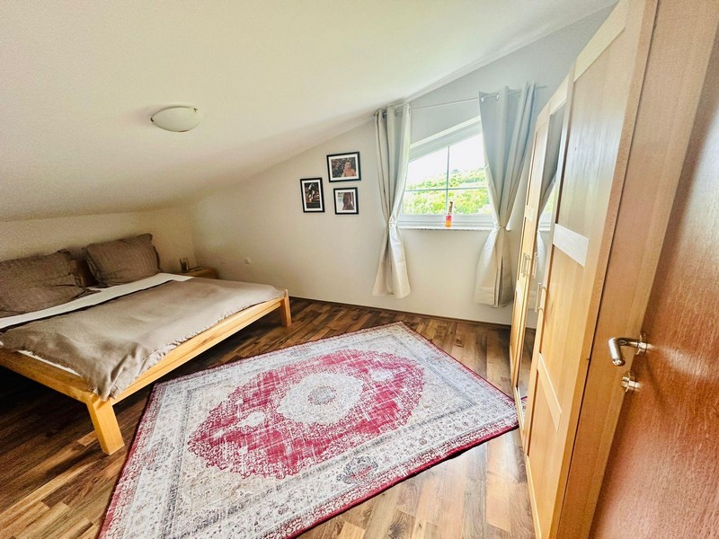 Bedroom with sloping ceiling and window
