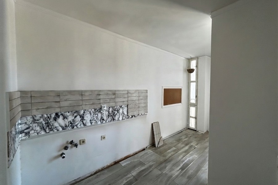 Cooking area with tiled wall and window