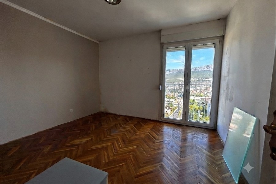 Bedroom with herringbone parquet and view