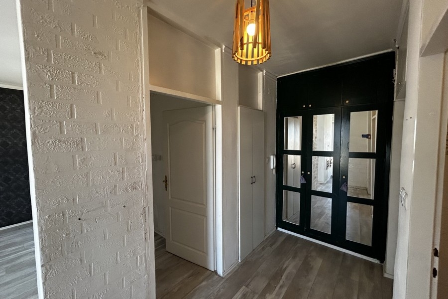 Hallway with built-in cupboard and glass door