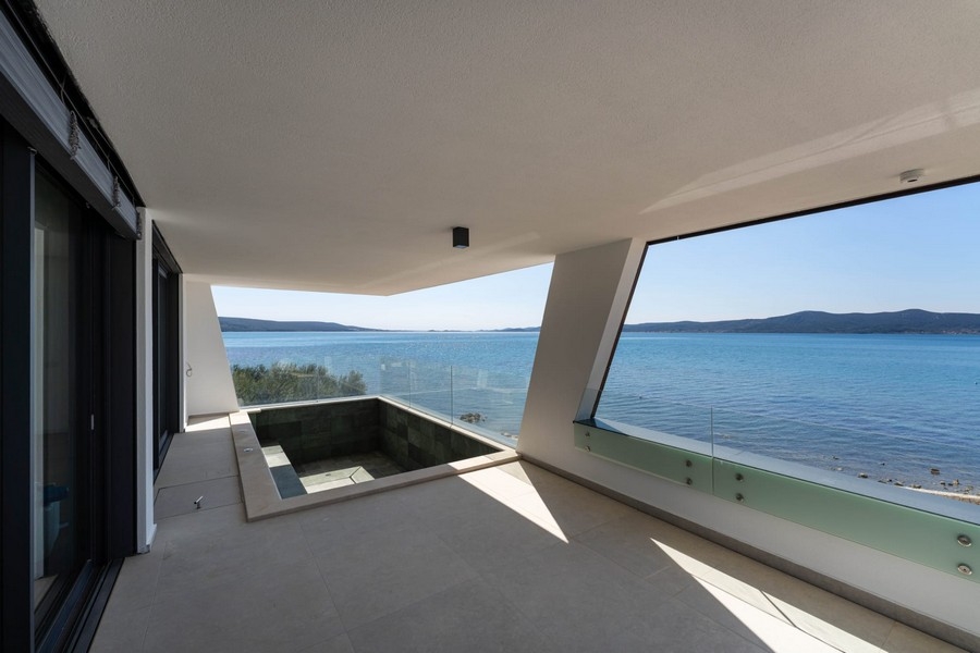 Covered terrace with pool and panoramic sea views