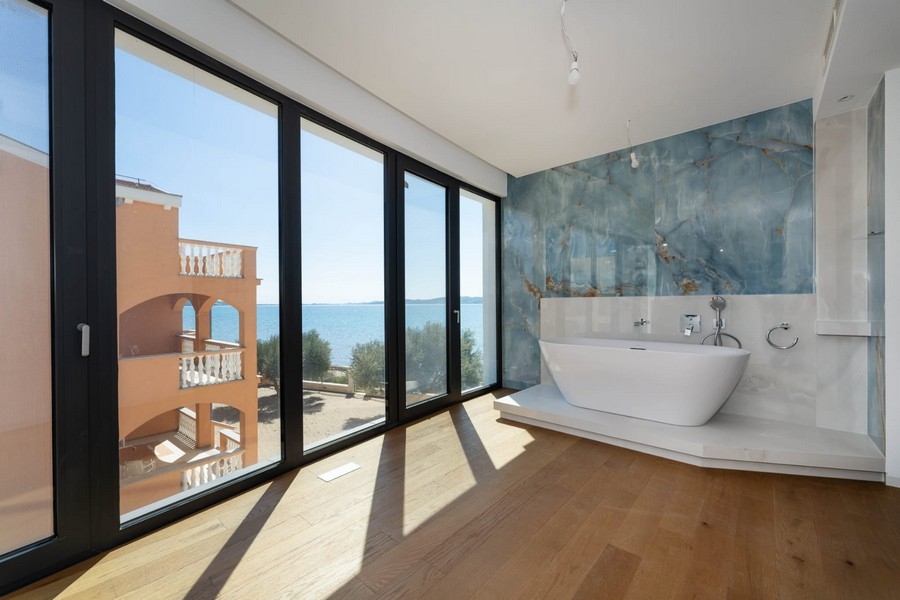 Bathroom with free-standing bathtub and sea views