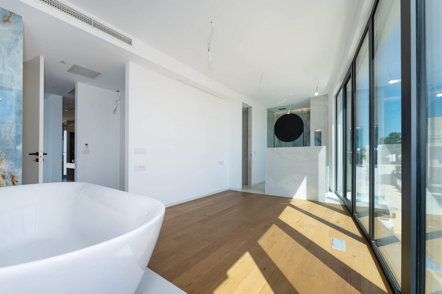 Bathroom with bathtub and large windows