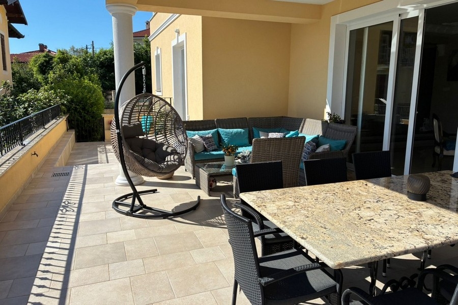 Covered terrace with seating area and dining table