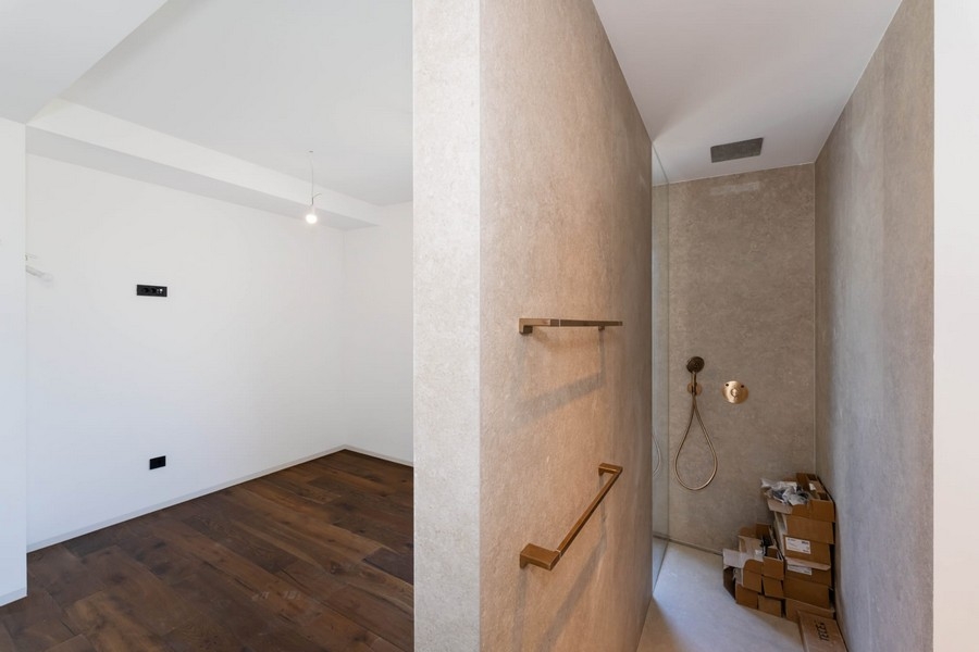 Room with wooden floors and walk-in shower