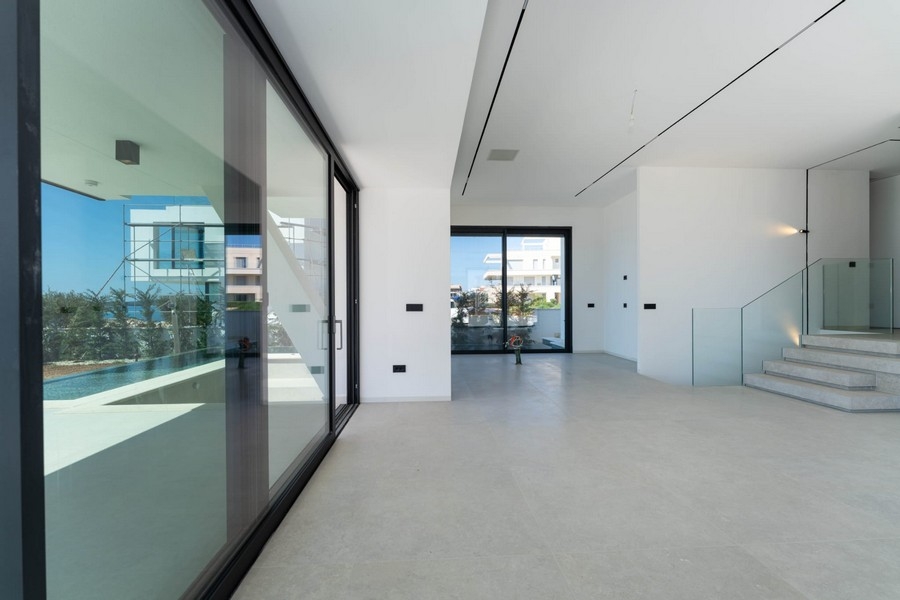Open living area with large glass surfaces and stairs