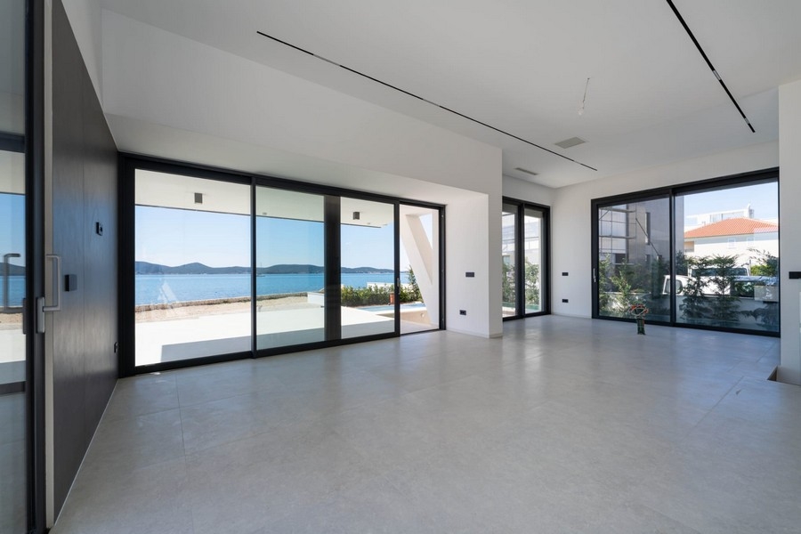Bright living room with panoramic windows and sea views