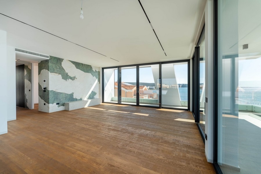 Living area with floor-to-ceiling windows and marble wall