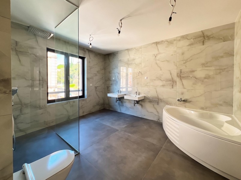 Bathroom with free-standing marble-look bathtub