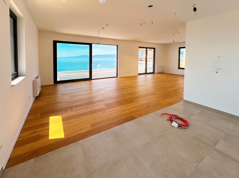 Living room with floor-to-ceiling windows and sea views