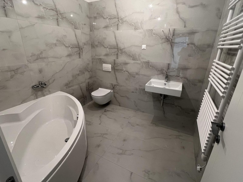 Bathroom with marble-look bathtub