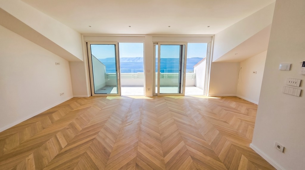 Living room with herringbone parquet and terrace access
