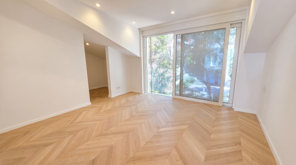 Bright room with a sloping ceiling and large window