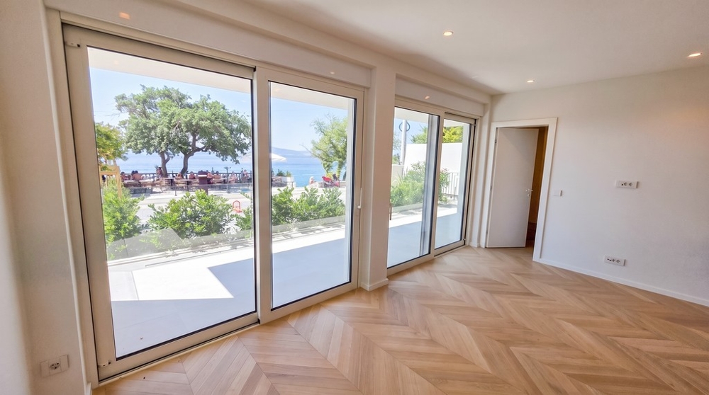 Living room with floor-to-ceiling windows and terrace access