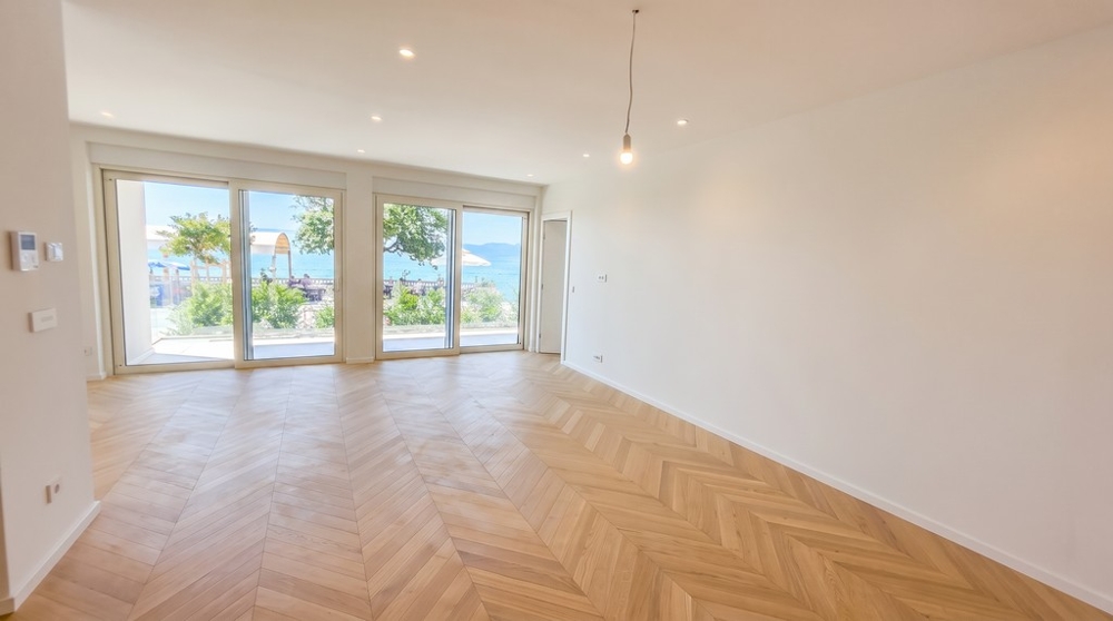 Bright living area with herringbone parquet floors and sea views