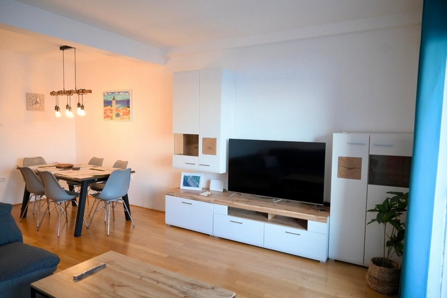 Living room with dining table and TV wall