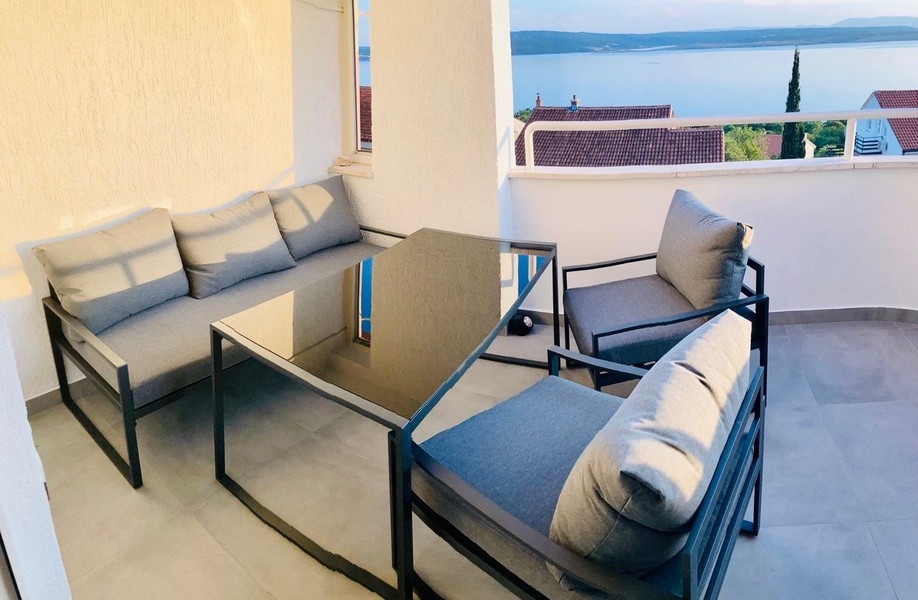 Balcony with lounge furniture and sea views