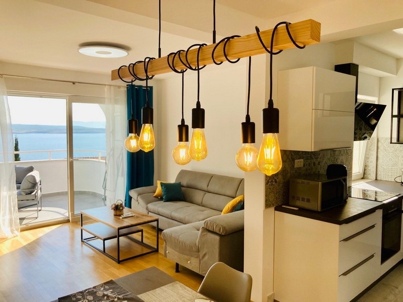 Open plan living and kitchen area with sea views