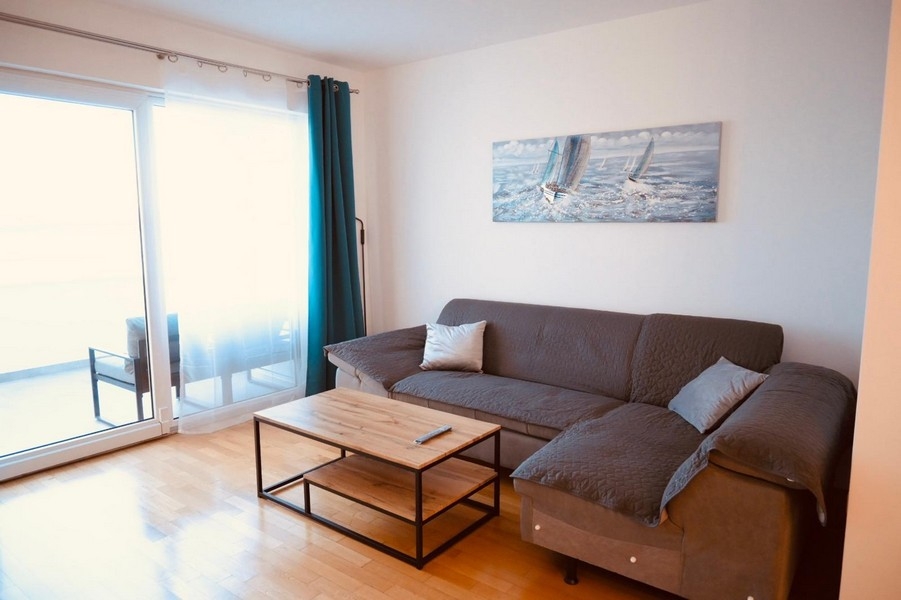 Living room with sofa and balcony access