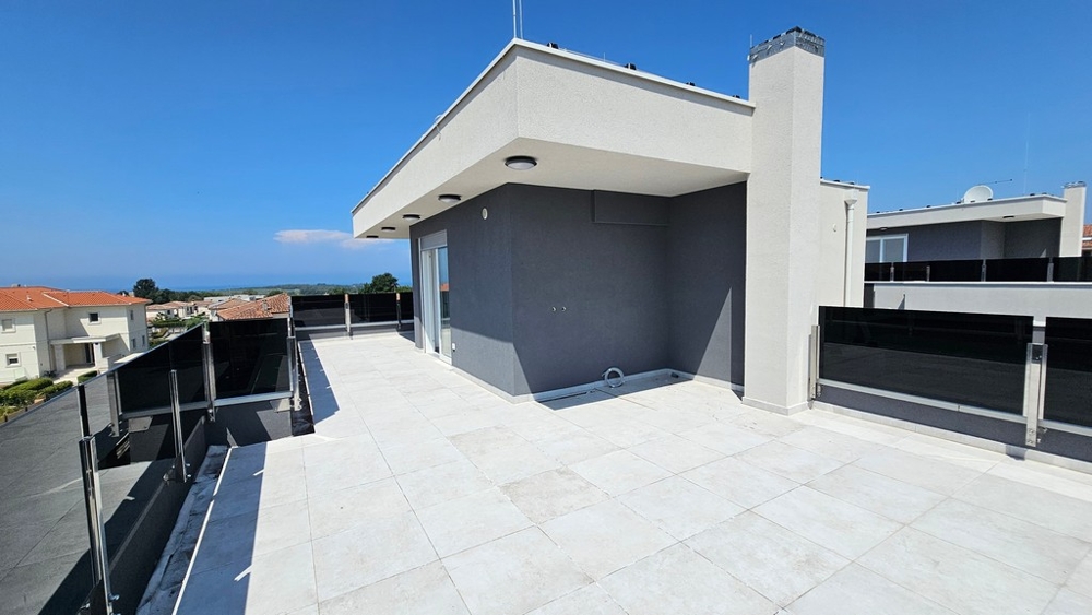 Large roof terrace of the apartment with a view of the sea in Croatia