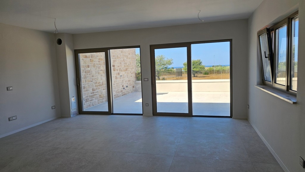 Living area with glass front and view of the terrace in Umag Croatia