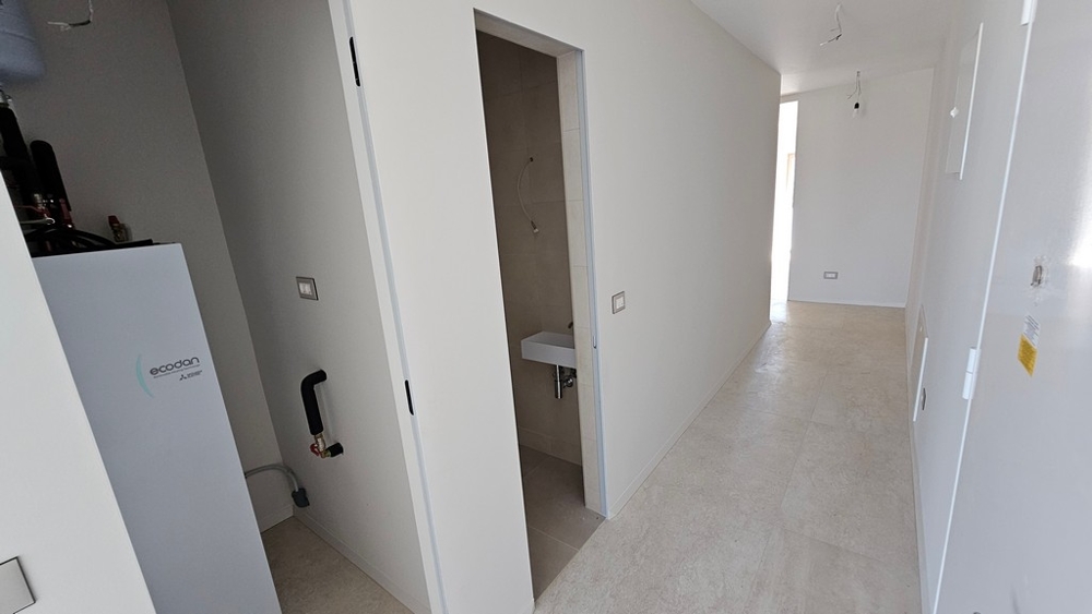 Hallway with building services and toilet