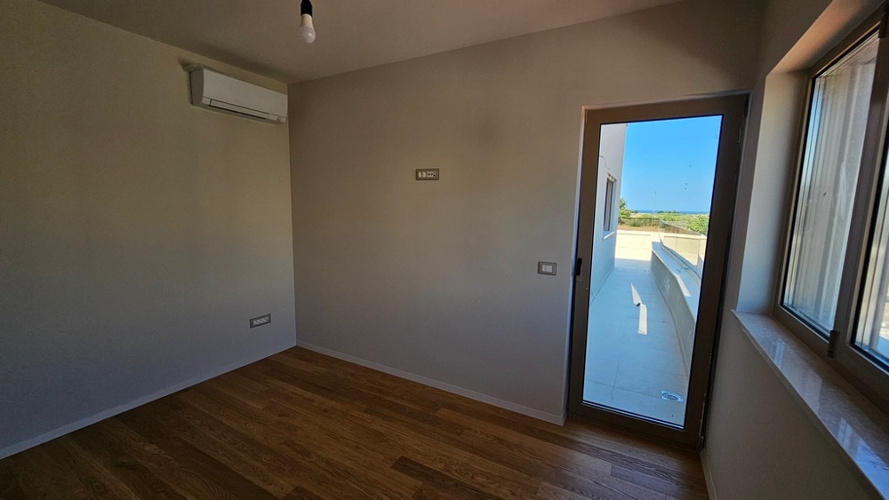Bedroom with patio door and sea view