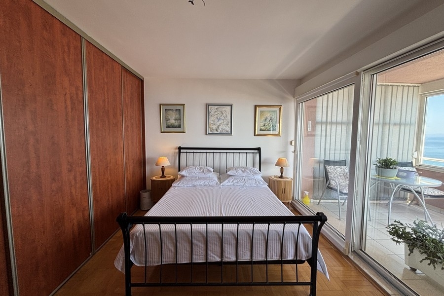 Bedroom with built-in wardrobe and loggia access