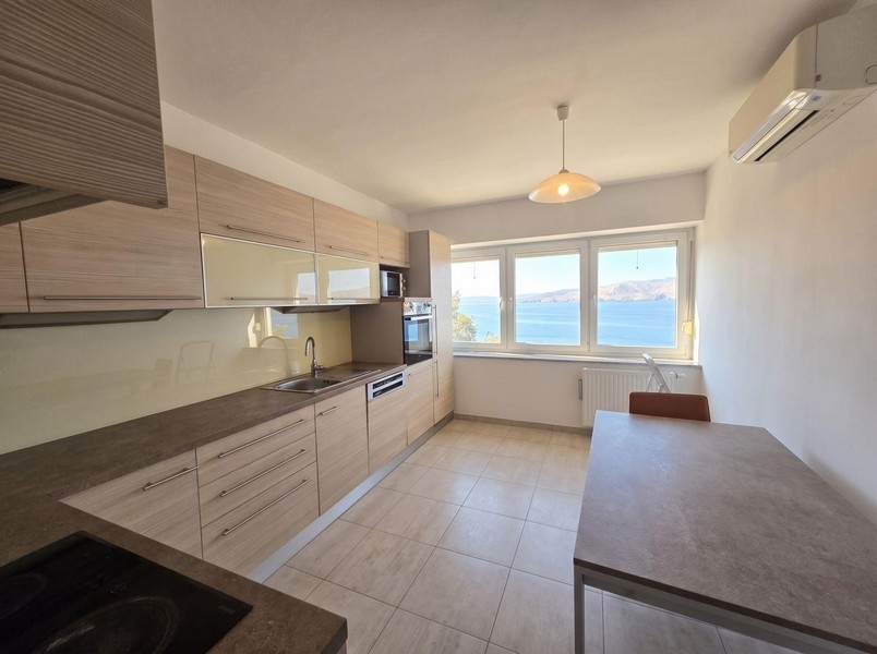 Kitchen with air conditioning and window to the sea