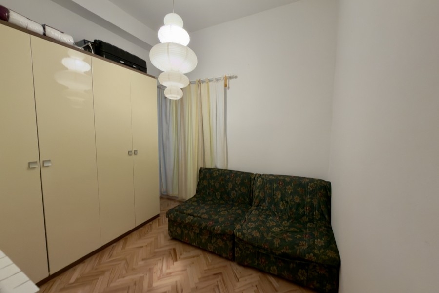 Bedroom with wardrobe and sofa